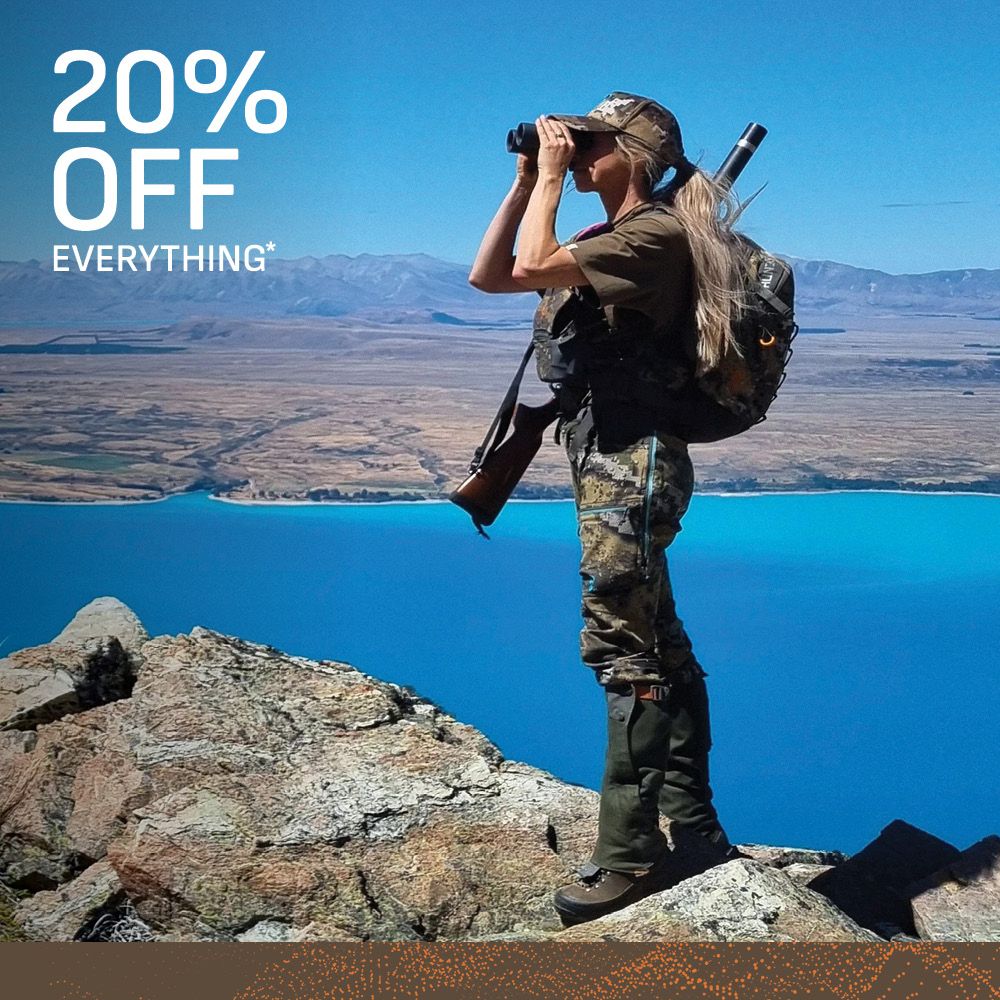 woman wearing camouflage clothing, gaitors and cap whilst hunting carrying a backpack