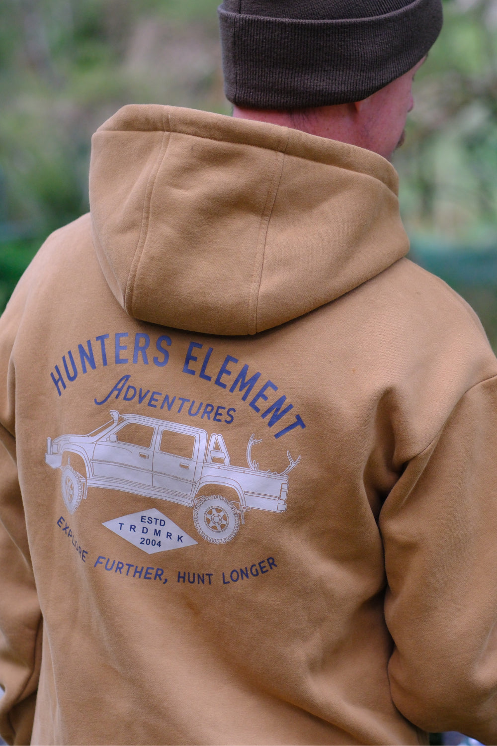 Person wearing a brown hoodie with 'Hunters Element Adventures' logo on the back.