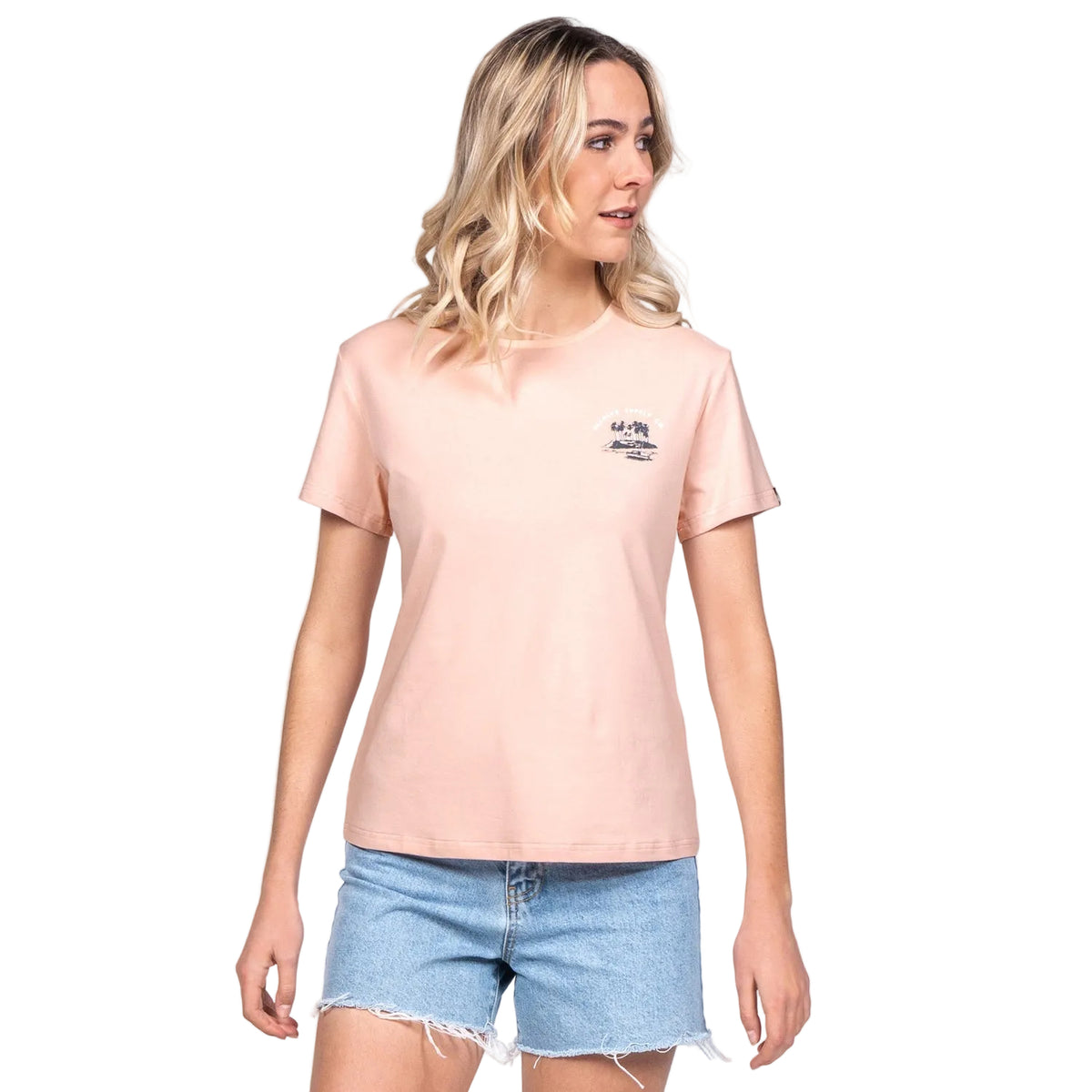 Woman wearing a light pink t-shirt with a logo and denim shorts on a white background