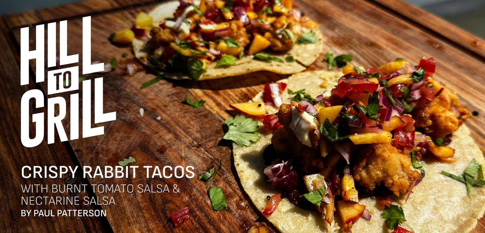 Crispy rabbit tacos with burnt tomato salsa on a wooden board, featuring 'Hill to Grill' branding.