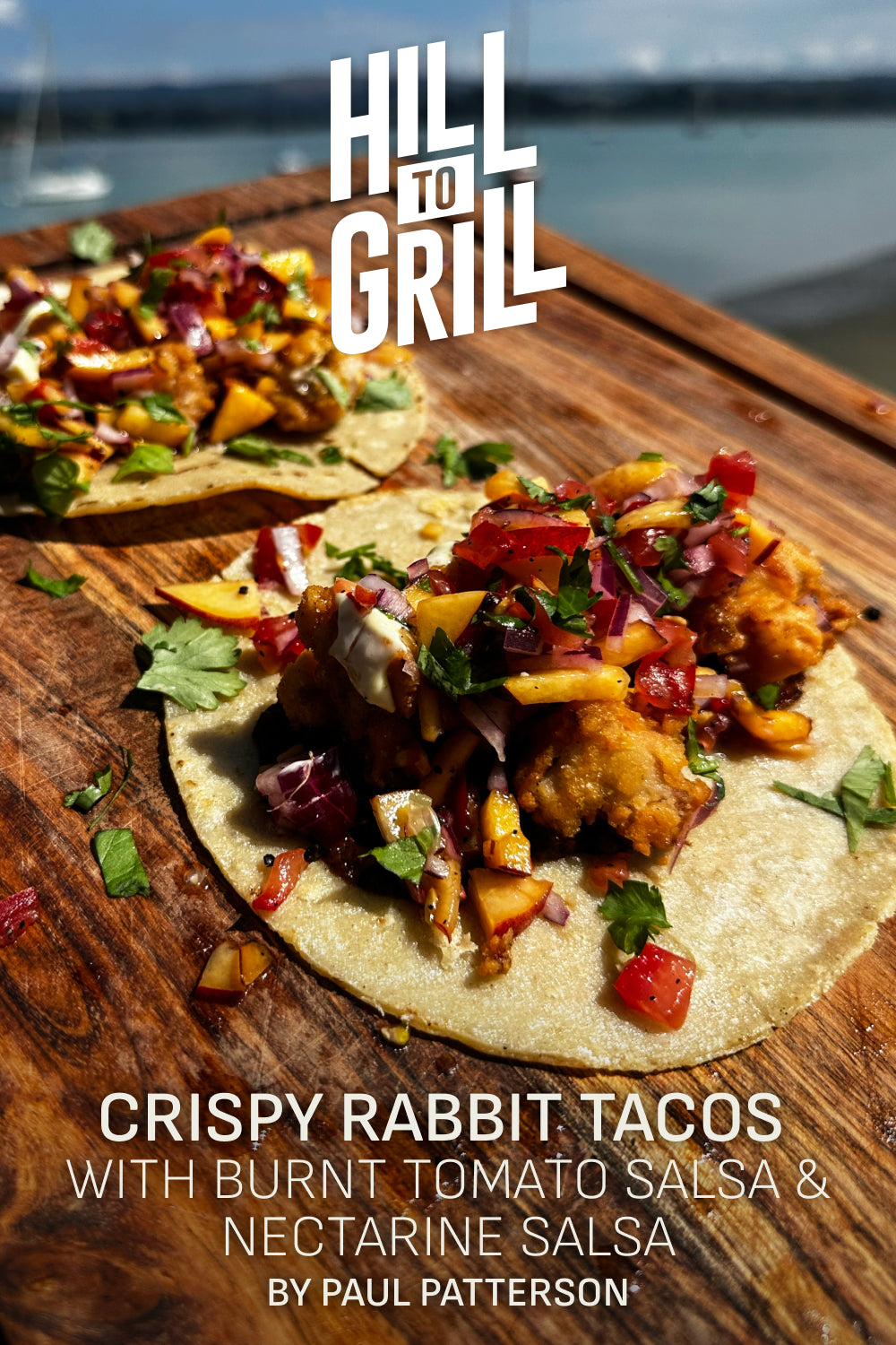 Crispy rabbit tacos with burnt tomato salsa and nectarine salsa on a wooden board by the water.
