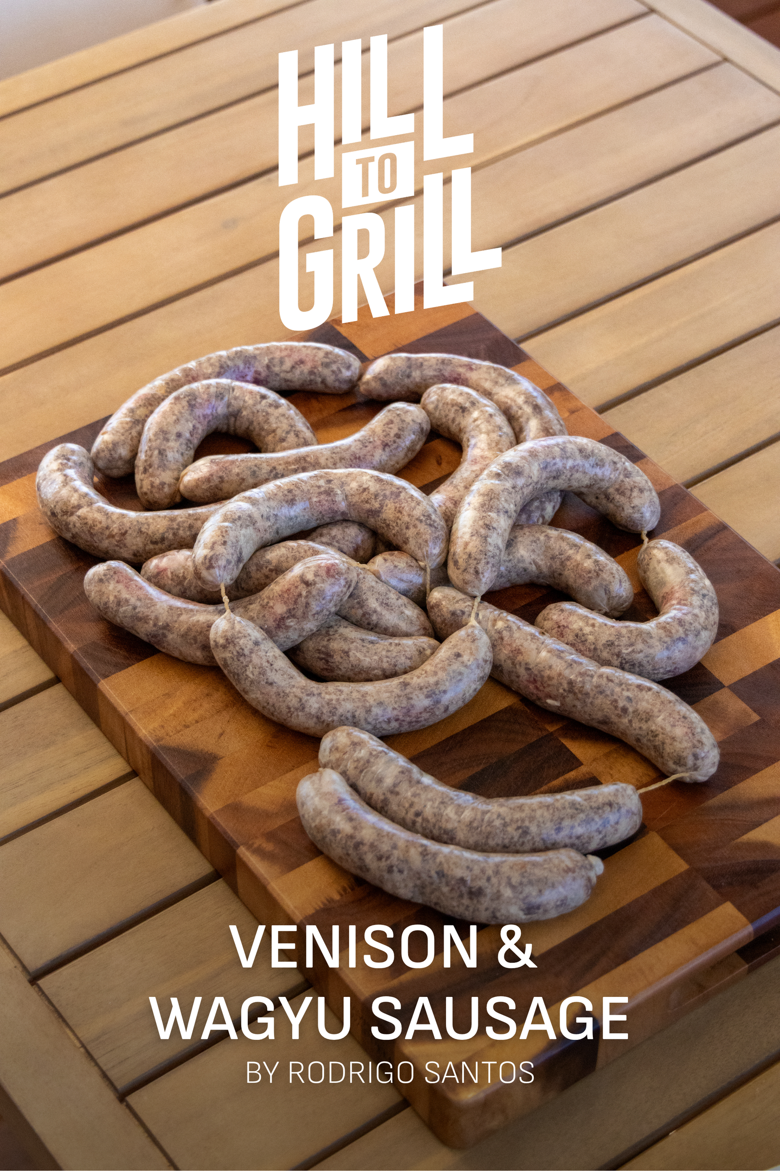 Venison and Wagyu sausages on a wooden cutting board with 'Hill to Grill' branding.
